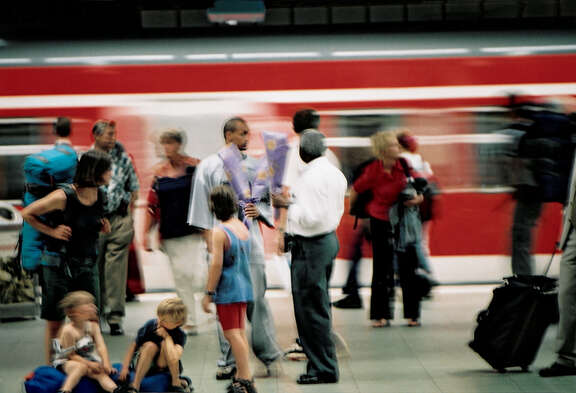 Passengers on platform in front of suburban train