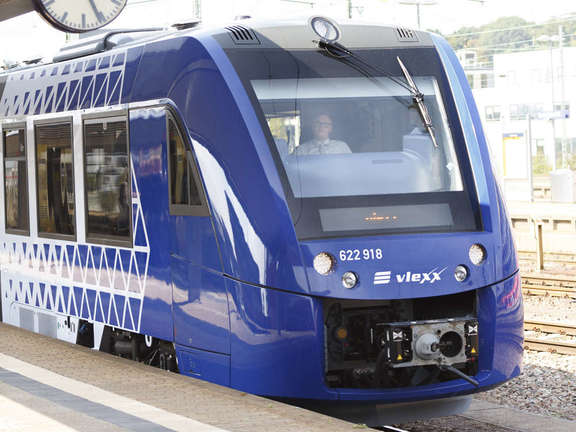 Vergrößerte Ansicht: blauer Zug Coradia Lint54 / Lint81 am Bahnsteig unter einer Bahnhofsuhr stehend