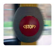 Close-up: red stop button, below red and blue stop button in a bus