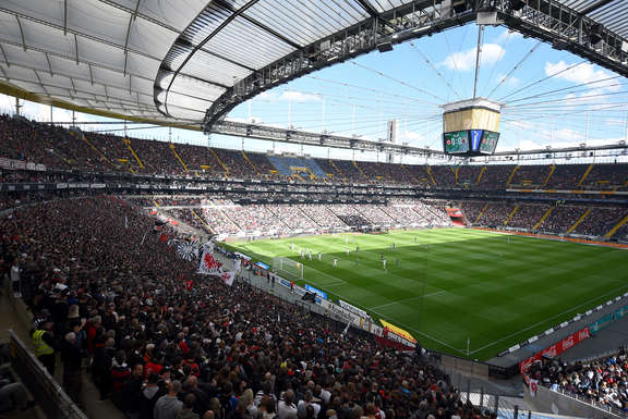 Football stadium with fans and players on the field