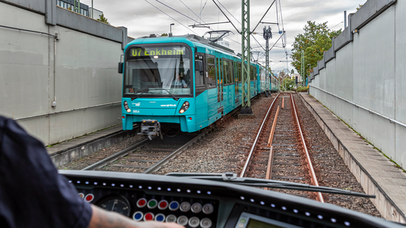 Blick aus dem Führerhaus auf das Gleisbett und eine entgegenkommende U-Bahnlinie