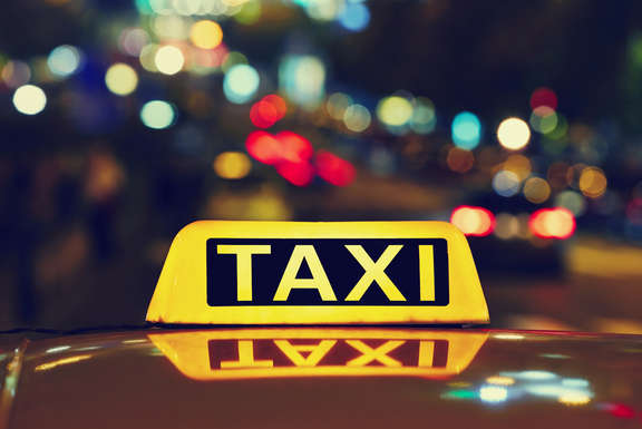 lighted taxi sign on a car roof