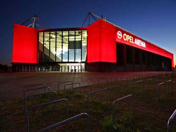 Exterior view of the red illuminated Opel Arena at night