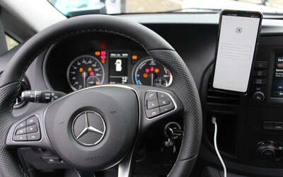 View of the driver from the steering wheel, speedometer and smartphone