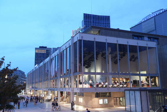 Illuminated stretched glass building in the twilight