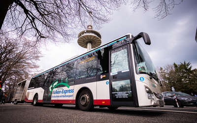 Bus Vogelsberger Vulkan Express vor dem Funkturm des Hoherodskopfs