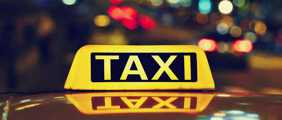 lighted taxi sign on a car roof