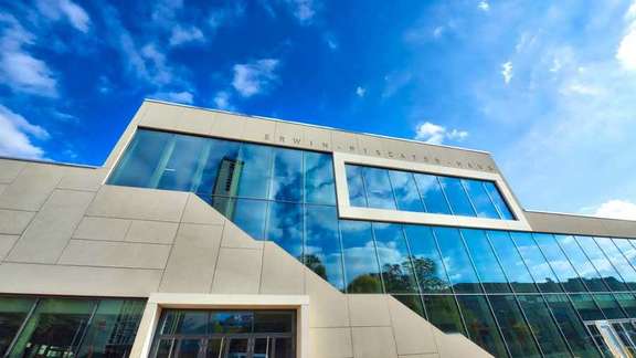 modern building facade with large grey stone slabs and huge glass front 