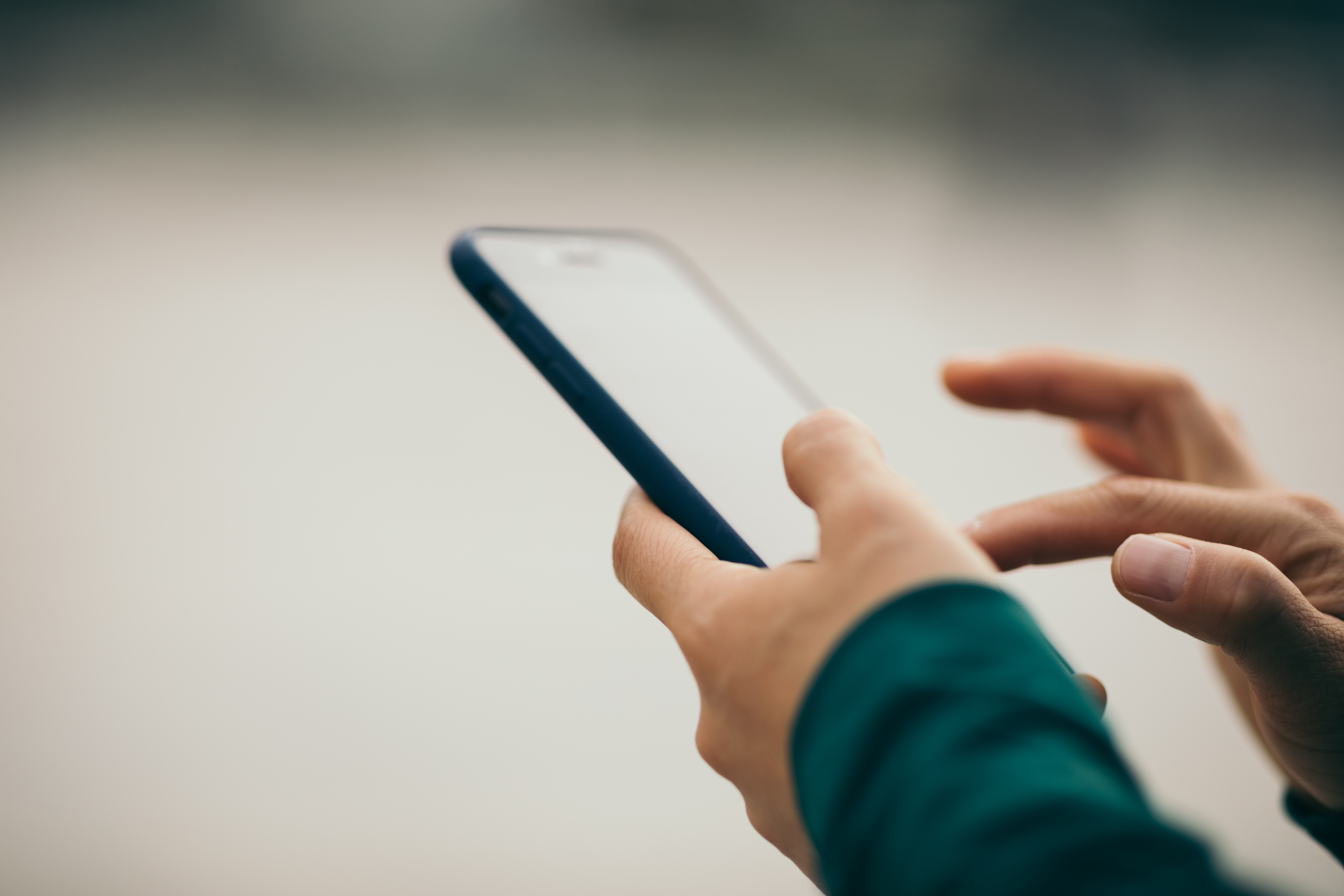 Person tippt auf Smartphone.